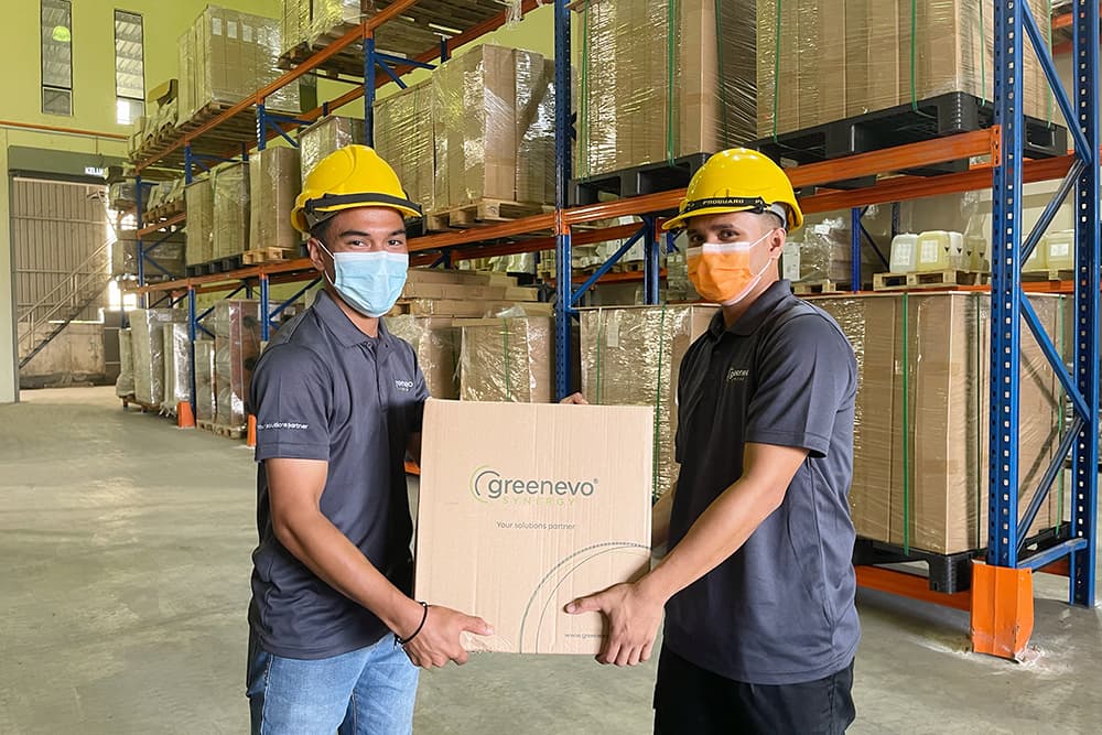 Greenevo Synergy staff handling a branded box in the warehouse